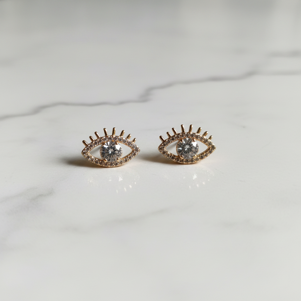 Aretes Ojo de Luz flat lay mármol